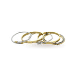 The Dynamic Stack, a five-piece bracelet stack with a mix of gold and silver finishes. It includes a silver cable wire bracelet, a gold knot bangle, a gold bangle with cubic zirconia accents, a two-tone chain bracelet, and a simple gold bangle.








