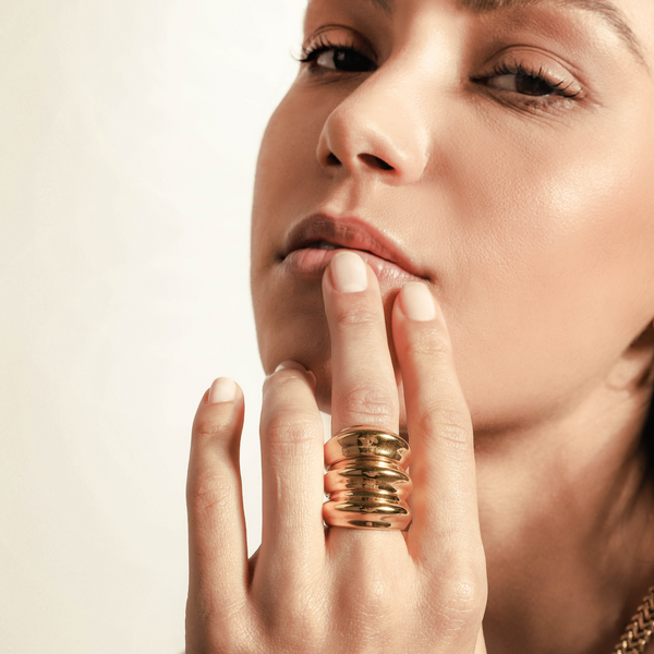 Model wearing the Triplet Ring which  is made out of Stainless steel 18k gold plated. It comes with 3 identical separate rings.