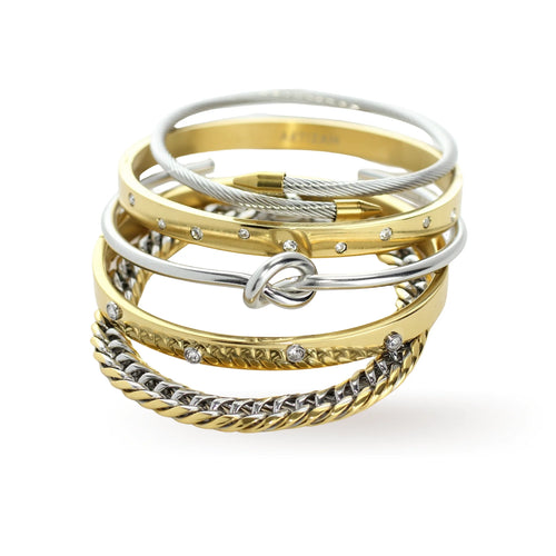 The Dynamic Stack, a five-piece bracelet stack featuring a mix of gold and silver bangles, a gold chain bracelet, and a silver cable wire bracelet. Some bangles are accented with cubic zirconia stones.








