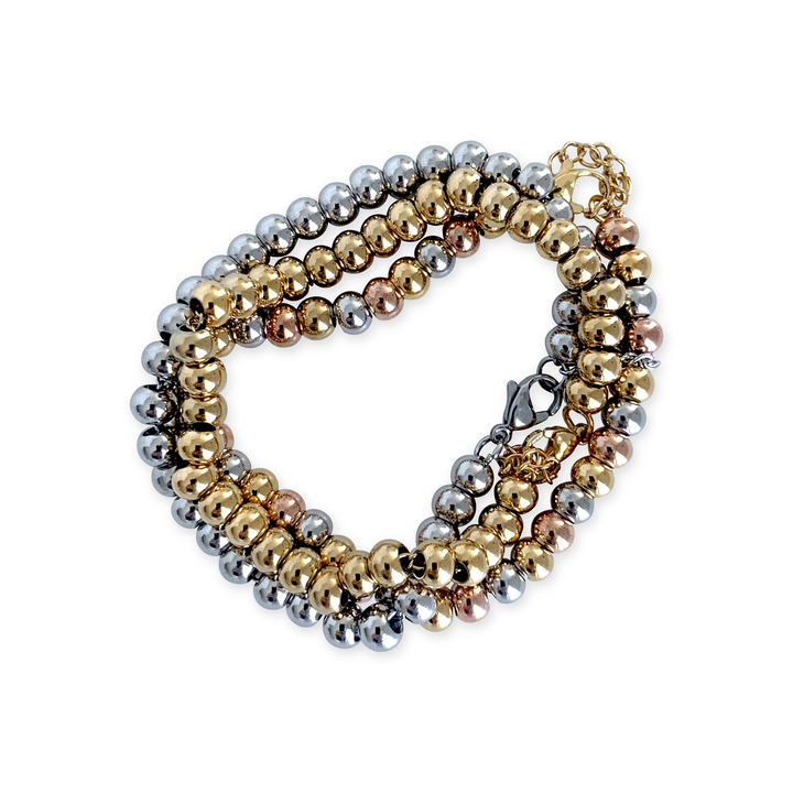 Three PUNTITOS BRACELETS . One is a made of gold plated circle beads, other one is rhodium plated and the other one is a mix of gold and silver beads.