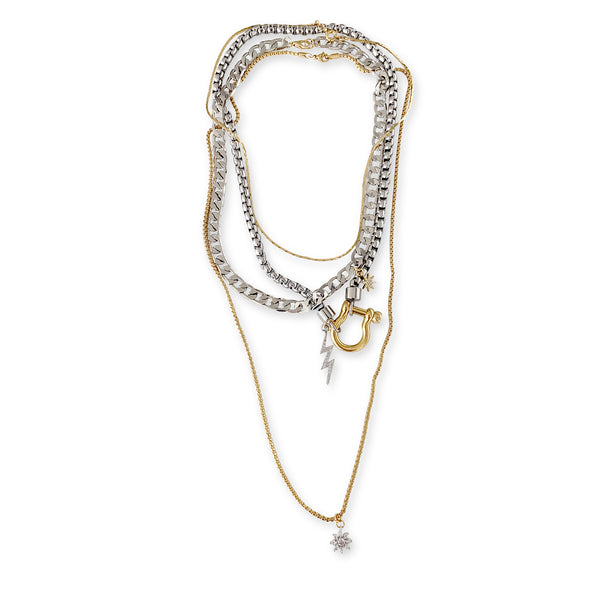 Herradura Chich Set which is a 4 Chains Layered Set. It comes with thin gold necklace, silver chain with gold herradura clasp and lightning bolt charm, flat silver chain and long thin chain with a Micro Pave sun pendant.