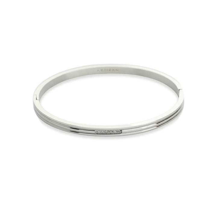 The Thin Ring, which is a sleek and minimalist silver-toned bangle bracelet, features a refined design with a delicate pavé accent for subtle sparkle. This single-piece bracelet is perfect for layering or wearing alone for a sophisticated touch. ||| SILVER