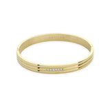 The Lane Bangle, a polished gold bangle featuring a sleek, minimalist design with a subtle row of sparkling stones on the front. This elegant bracelet can be worn solo or stacked with other bangles for a refined, sophisticated look, perfect for both casual and formal occasions.