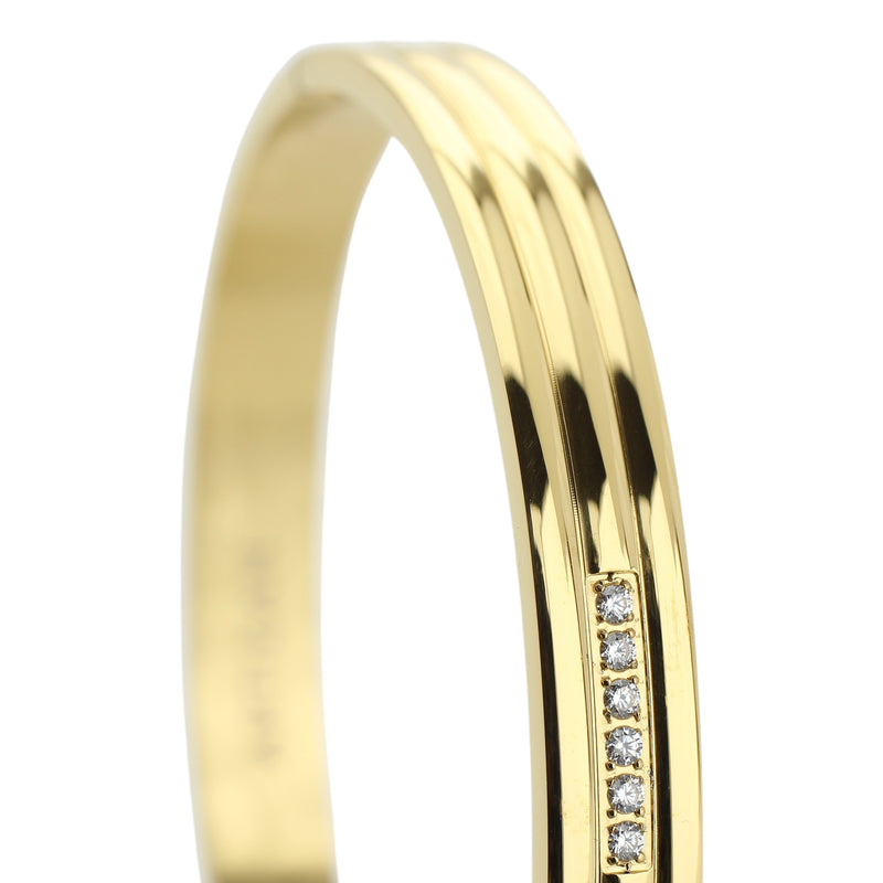 The LANE BANGLE which is made of gold plated stainless steel with six tiny cubic zirconia.