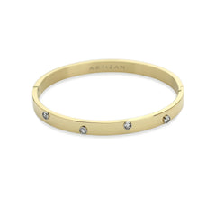 The ON BANGLE, which is a single, sleek gold bracelet, features a minimalist design adorned with sparkling crystal accents evenly distributed along its circumference. This versatile piece is perfect for both standalone wear and stacking with other bangles to add an elegant touch to any look.