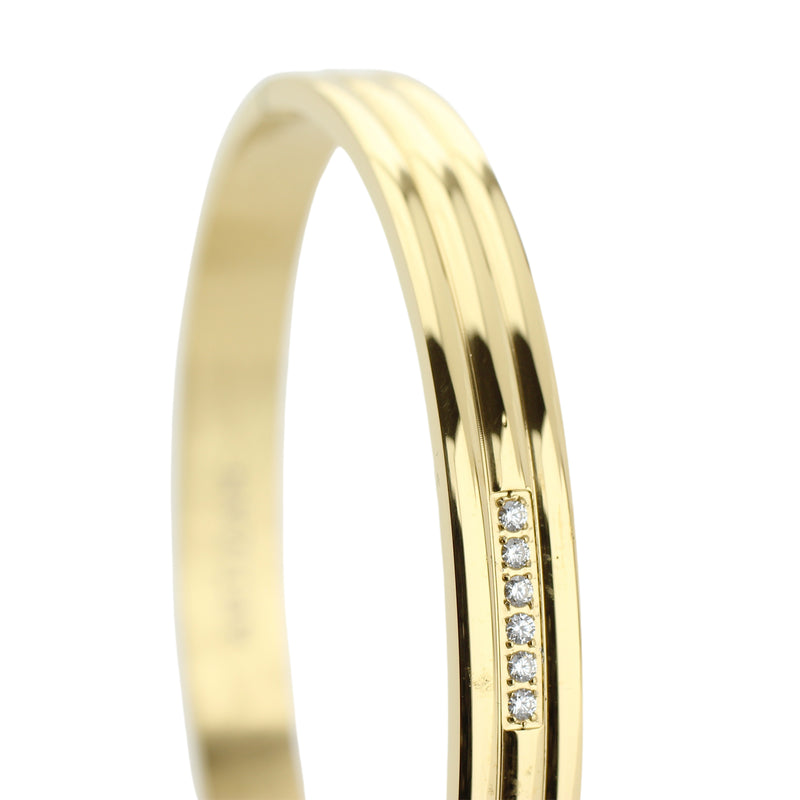 The MIDDLE LANE BANGLE which is made of gold plated Stainless steel with six tiny Cubic zirconia and dimensions of 2.8" x 1.77".