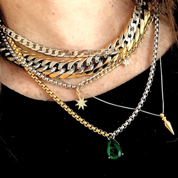 Model wearing the 3 piece Emerald and Mix set which comes with a half gold and half silver thin chain with green emerald stone in the center, silver chain with star pendant, and the Mix chain which comes in Stainless Steel Gold & Silver Chain.