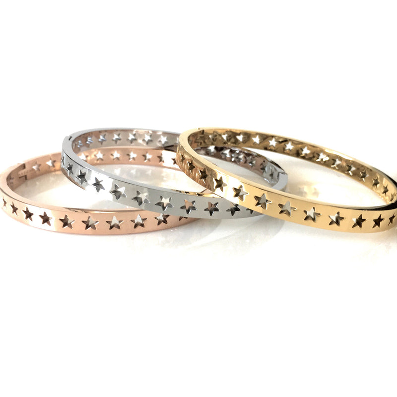 Three Shooting Stars bangles in Gold plated, Rhodium plated, Rose Gold variants. It has cut out stars around them.