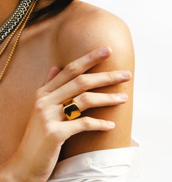 Model wearing the Forever Ring Gold which is made of 18k Gold plated stainless steel. She is also wearing the Herradura Layered Set.