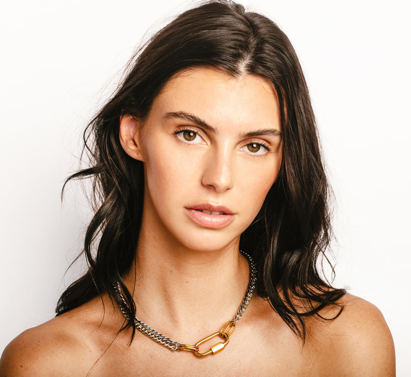 Model wearing the Anna silver necklace which is made of Rhodium plated stainless steel chain with an 18k gold plated carabiner.