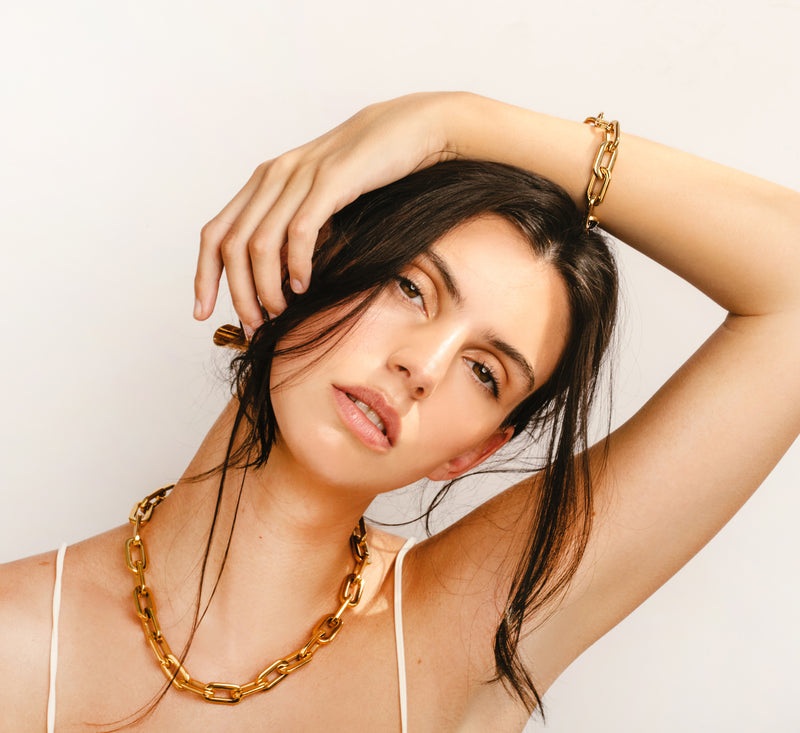 Model wearing the Puerto Gold seet which comes with a Puerto Chain necklace and bracelet in Gold plated stainless steel.