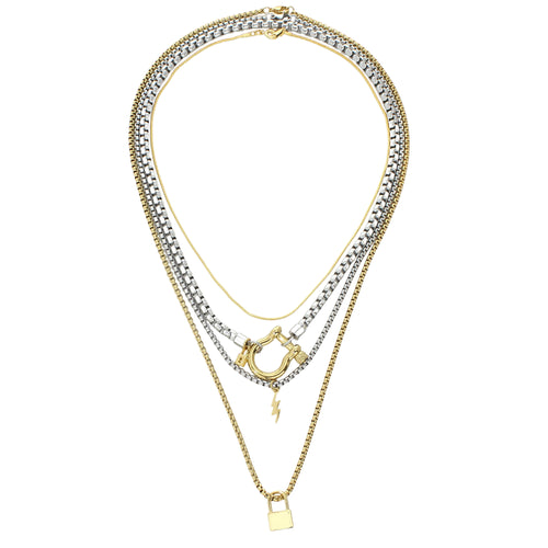 The Herradura Lock Layered Necklace Set, a four-piece silver and gold necklace set featuring a variety of chains with a gold horseshoe clasp, a lightning bolt charm, and a padlock charm.