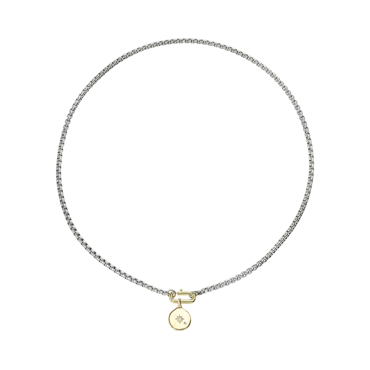 The BOX CHARM NECKLACE, a stylish silver chain necklace with gold clasp featuring a unique box-shaped pendant with a diamond accent.