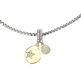 Silver necklace with the Drop Star Clip On Charm, a gold charm with a teardrop shape, a diamond-encrusted star, and a silver clip-on bale and also  circle diamond encrusted clip on charm.