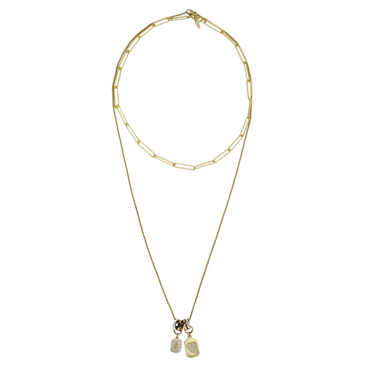 The DUO CHARM NECKLACE which is a Set of 2 separate chains made of 925 sterling silver 18K gold plated bold link chain that is 16" long and a 1mm wide gold plated chain that is 24" long with Dainty pave heart and star charms.