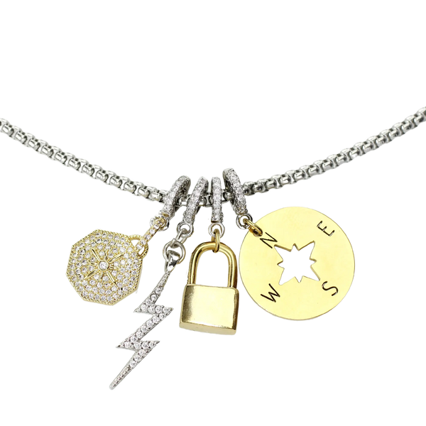 Stainless steel chain with four charms. The compass charm, lock charm, lightning bolt charm and the NORTH CLIP ON CHARM which is made of Pave Clip on Stainless steel 18k gold plated Zirconia north star charm.