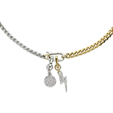 The can opener necklace in gold with silver can opener clasp with a gold lightning bolt charm with pave-set diamond-like stones and a a circle charm with star burst detail.