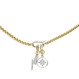 The can opener necklace in gold with silver can opener clasp with a gold lightning bolt charm with pave-set diamond-like stones and a a circle charm with star burst detail.