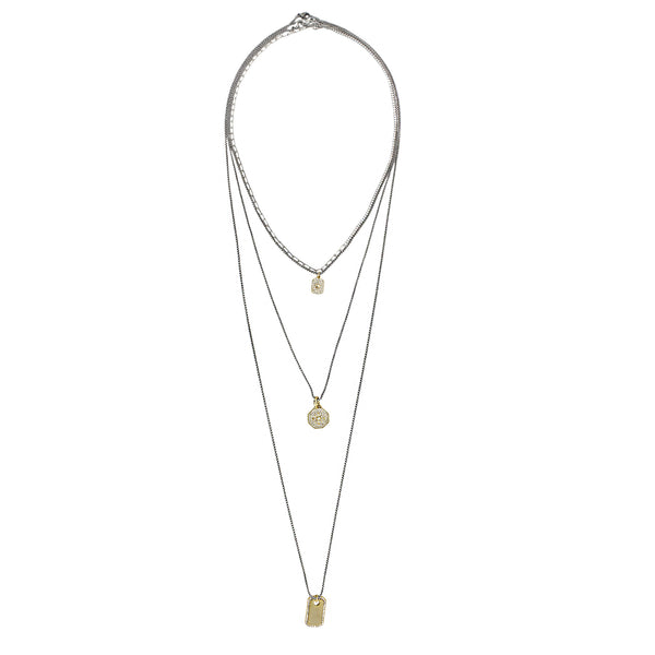 THE CHARM NECKLACE SET which includes 4 separate layered chains. Three chains are made of 1mm, Stainless steel Rhodium plated with dainty gold filled charms and one Silver Tennis-Chain Necklace: Half-Half Chain with Sterling Silver & Zirconia Gems.