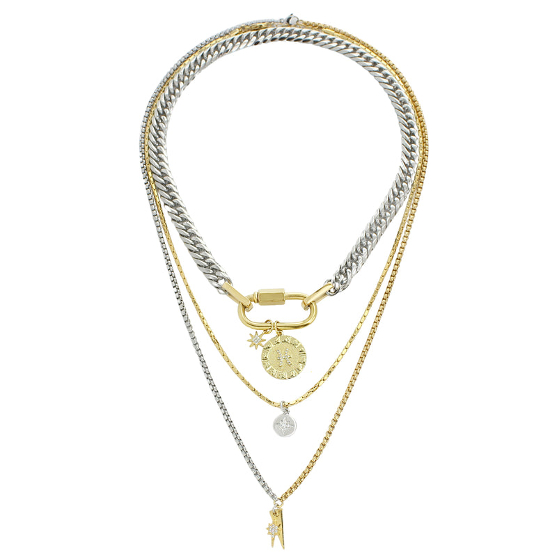 The Anne Zodiac Necklace which is a three pieces layered necklace set. Includes one silver chain with 18k gold plated carabiner and Gold Filled Pisces Zodiac with Micro Pave Constellation charm, thin gold necklace with silver circle charm and another long necklace in half gold and silver with spike shaped charm and Gold Plated Micro Pave Studded Star.