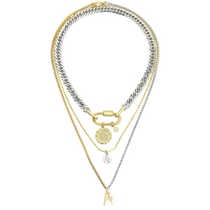 The Anne Zodiac Necklace which is a three pieces layered necklace set. Includes one silver chain with 18k gold plated carabiner and Gold Filled Scorpio Zodiac with Micro Pave Constellation charm, thin gold necklace with silver circle charm and another long necklace in half gold and silver with spike shaped charm and Gold Plated Micro Pave Studded Star. 