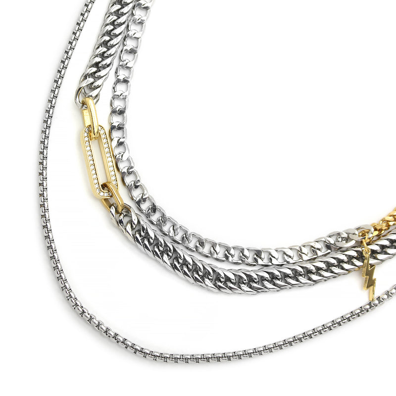 The MADDALENA NECKLACE SET includes 3 separate chains. One is a stainless steel chunky chain with gold oval link  with zirconia stones.  One is  a mix gold & silver chain with an 18k gold plated lightning charm and the longest is a plain stainless steel chain.
