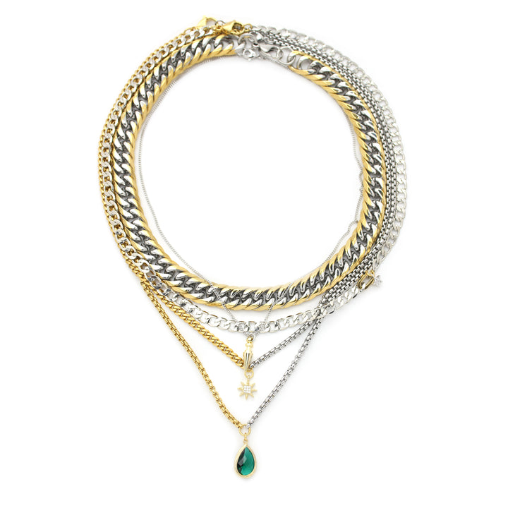 CAMALEON Set. Comes with a silver flat chain with small star fiamond studded charm, Chunky Palma chain, Silver chain with sun paved charm, long thin silver necklace with gold plated spike and Mix silver and gold chain with an emerald crystal pendant.