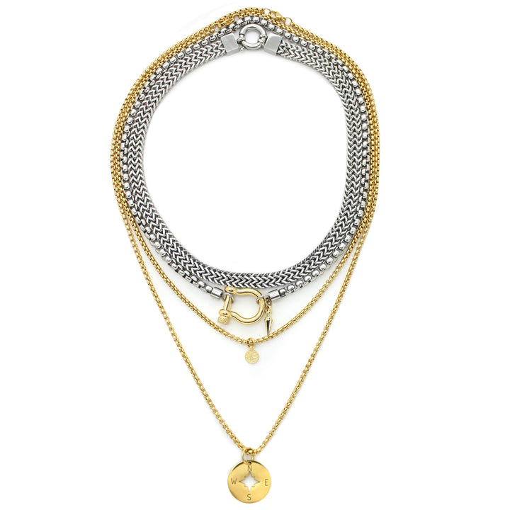 The HERRADURA LAYERED NECKLACE SET in Gold variant which includes 4 separate chains. It includes the Marinero silver chain, Stainless steel chain with an 18k gold plated horseshoe clasp and spike pendant. The other necklaces are 2 thin gold plated chains with the compass disc and the ottoman disc pendants. |||Gold