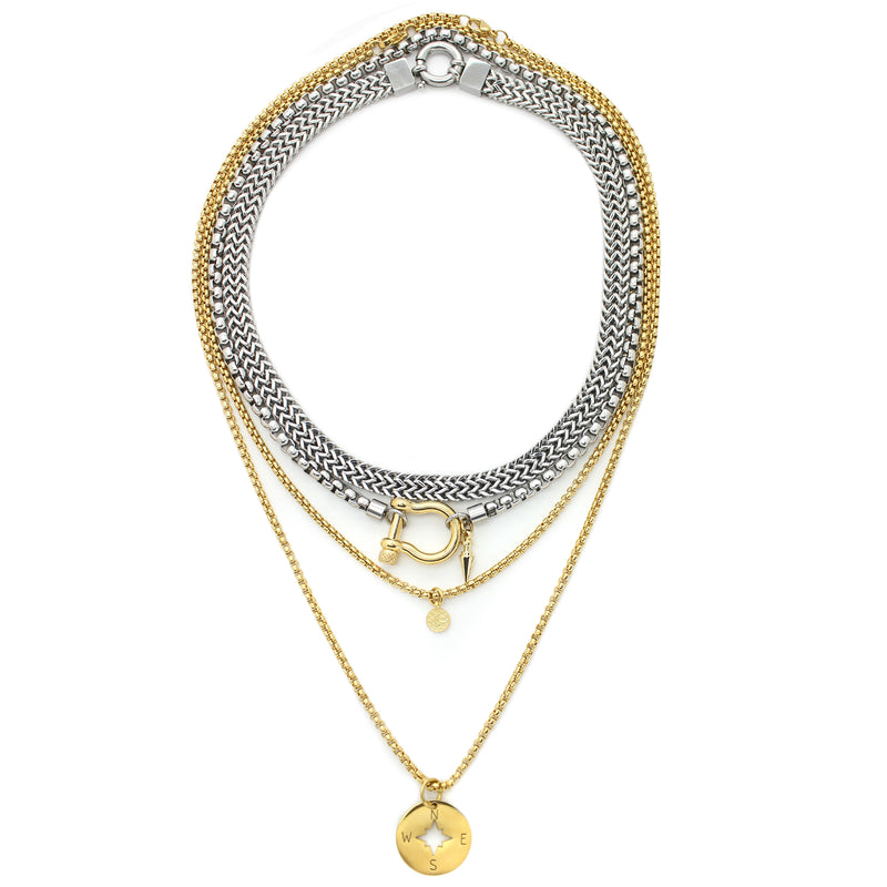 The HERRADURA LAYERED NECKLACE SET in Gold variant which includes 4 separate chains. It includes the Marinero silver chain, Stainless steel chain with an 18k gold plated horseshoe clasp and spike pendant. The other necklaces are 2 thin gold plated chains with the compass disc and the ottoman disc pendants.