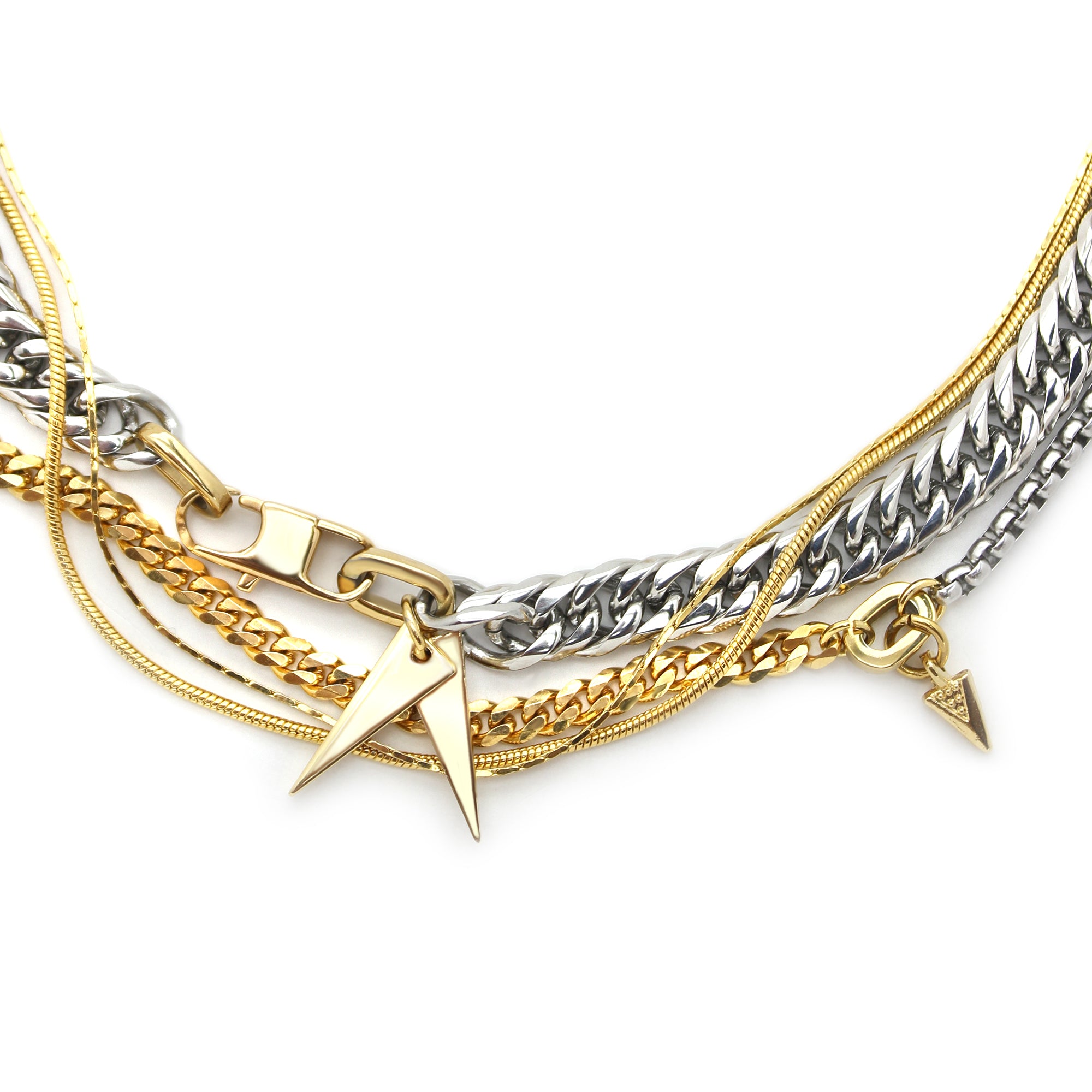 The STROMBOLI NECKLACE SET includes 4 separate chains. One is a stainless steel chunky chain with an 18k gold plated triangle charms, two thin gold necklaces and a half stainless steel and half 18k gold plated chain with a gold small triangle charm.
