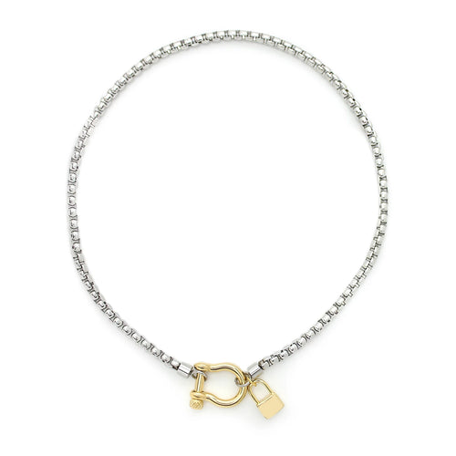The Herradura Lock Single Necklace, a silver chain necklace with a gold lock charm.