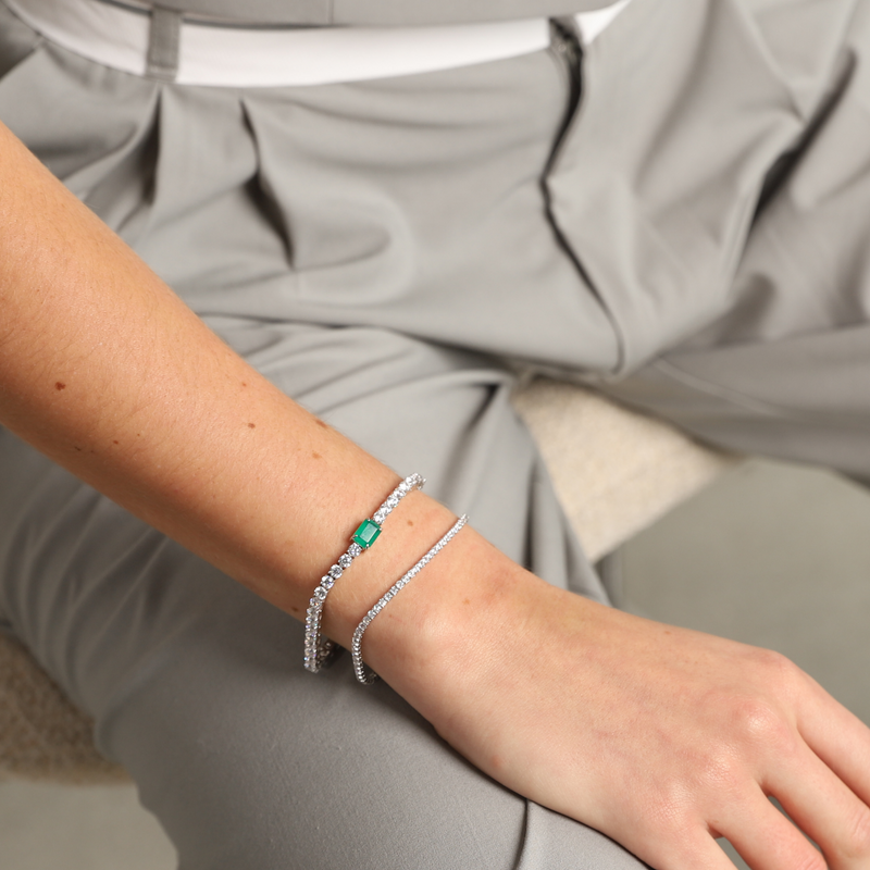 Model wearing the SPARKLING THIN TENNIS BRACELET which is made of 925 Sterling Silver and 2mm Round Cut Zirconia together with the EMERALD CUT TENNIS BRACELET.