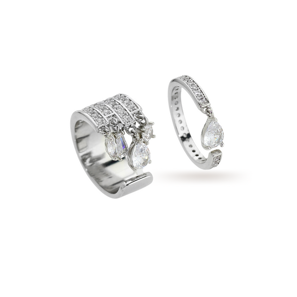 The TWIN RING which is a set of 2 separate styles decorated with shimmering pavé and pear-cut diamonds zirconia made of Rhodium plated copper. One ring is thicker than the other with similar zirconia stones and drop diamond design.