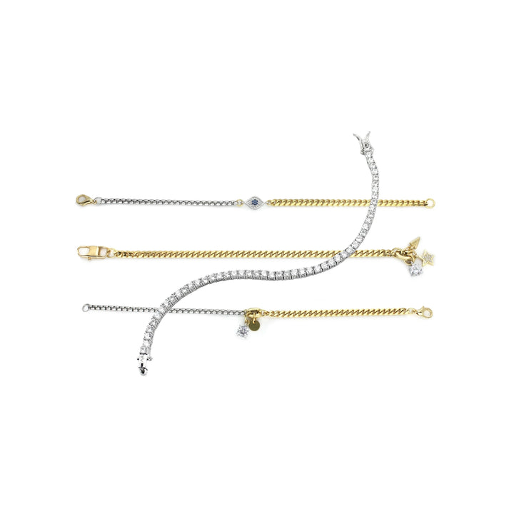 The BLENDED LUXE SET, a stylish four-piece bracelet set featuring a mix of gold and silver chains with sparkling diamond accents and delicate charms. 