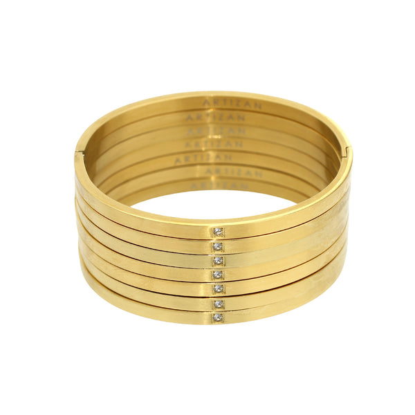 The WEEKLY MATTE STACK which is a 7 bangles stack made of 18k gold plated stainless steel with a tiny encrusted zirconia.