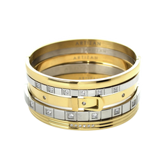 ANIMATED STACK: A luxurious stack of bangles featuring mixed metals in gold and silver tones. The set showcases a variety of designs including a buckle-inspired bangle with sparkling diamonds, a sleek gold bangle, and several minimalist silver bangles. The word "ARTIZAN" is subtly engraved on some of the bangles, adding a touch of elegance.