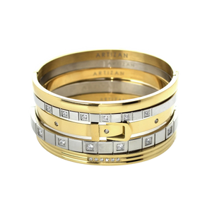 ANIMATED STACK: A luxurious stack of bangles featuring mixed metals in gold and silver tones. The set showcases a variety of designs including a buckle-inspired bangle with sparkling diamonds, a sleek gold bangle, and several minimalist silver bangles. The word 