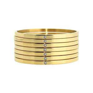 The Weekly Shiny Stack, a seven-piece gold bangle set with a minimalist design and subtle cubic zirconia accents.