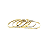 ANIMATED STACK: A luxurious stack of bangles featuring mixed metals in gold and silver tones. The set showcases a variety of designs including a buckle-inspired bangle with sparkling diamonds, a sleek gold bangle, and several minimalist silver bangles. The word "ARTIZAN" is subtly engraved on some of the bangles, adding a touch of elegance.