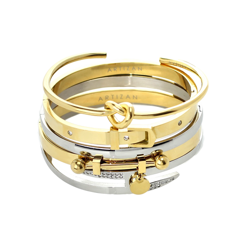 The Khanti Bracelet Stack, a five-piece gold and silver bracelet stack featuring bangles with a variety of  accents, including a knotted bangle, a buckle bangle with diamond-like stones, a bar bangle, and a bangle with diamond-like stones and a heart charm.