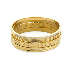 The Vivid Stack, a four-piece gold bangle set with various textures and cubic zirconia accents.