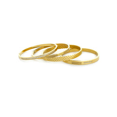 The Vivid Stack, a four-piece gold bangle set with various textures and cubic zirconia accents.