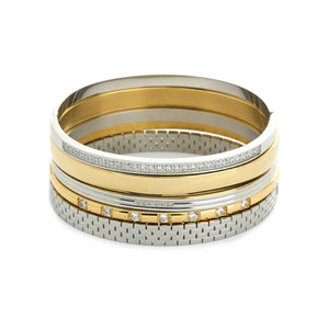 The Intense Stack, a five-piece gold and silver bracelet stack featuring bangles with various diamond-like accents and textured designs.