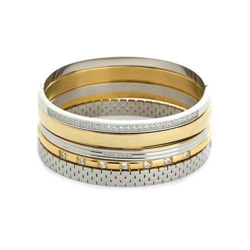 The Intense Stack, a five-piece gold and silver bracelet stack featuring bangles with various diamond-like accents and textured designs.