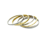 The Intense Stack, a five-piece gold and silver bracelet stack featuring bangles with various diamond-like accents and textured designs.