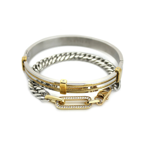 The Ischia Stack, a two-piece gold and silver bracelet stack featuring a gold bangle with textured detailing and a silver chain bracelet with a diamond-like encrusted clasp.