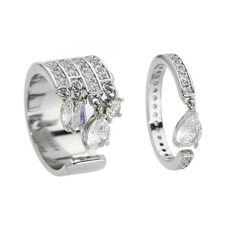 The TWIN RING which is a set of 2 separate styles decorated with shimmering pavé and pear-cut diamonds zirconia made of Rhodium plated copper. One ring is thicker than the other with similar zirconia stones and drop diamond design.