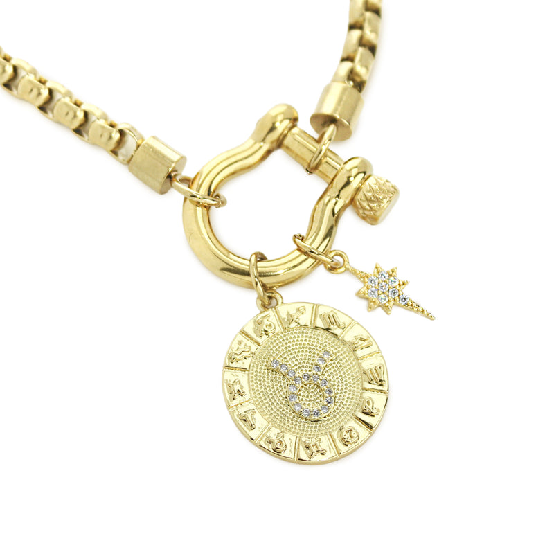 The Taurus Herradura Zodiac Necklace which is made of 18” Hypoallergenic Gold Plated Stainless Steel chain with 18K Gold Plated Horseshoe clasp and miniature star pendant and circular star sign micro pave Taurus constellation charm.