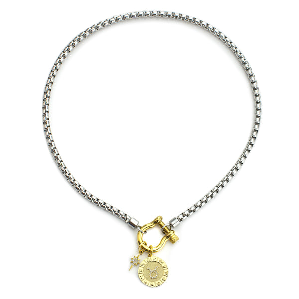The Taurus Herradura Zodiac Necklace which is made of 18” Hypoallergenic Rhodium Plated Stainless Steel chain with 18K Gold Plated Horseshoe clasp and miniature star pendant and circular star sign micro pave Taurus constellation charm.
