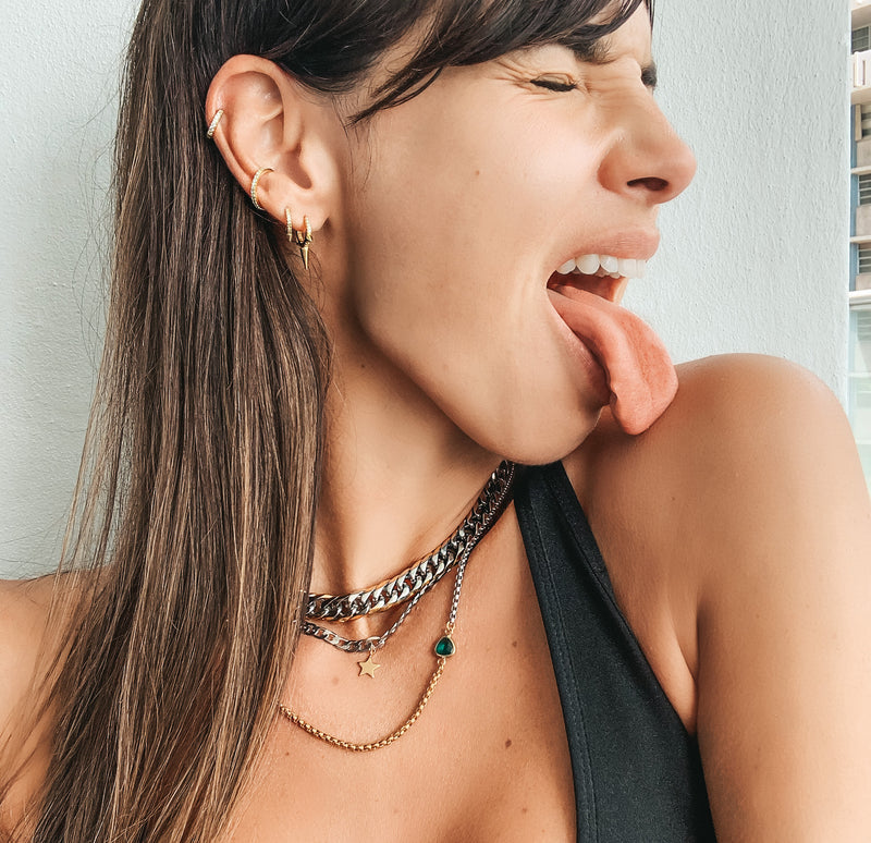 Model wearing the EAR PARTY GOLD SET - 3 & 2 HOLES.  She is wearing the palma chain necklace, chain with star pendant and half gold and silver necklace with emerald stone in the center.